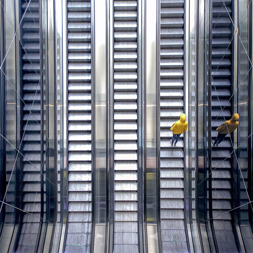 aerial view of person riding escalators